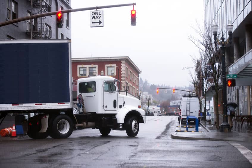 semi truck turning at a light