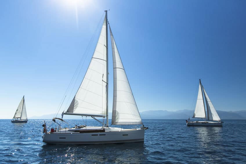sail boats sailing on a clear water