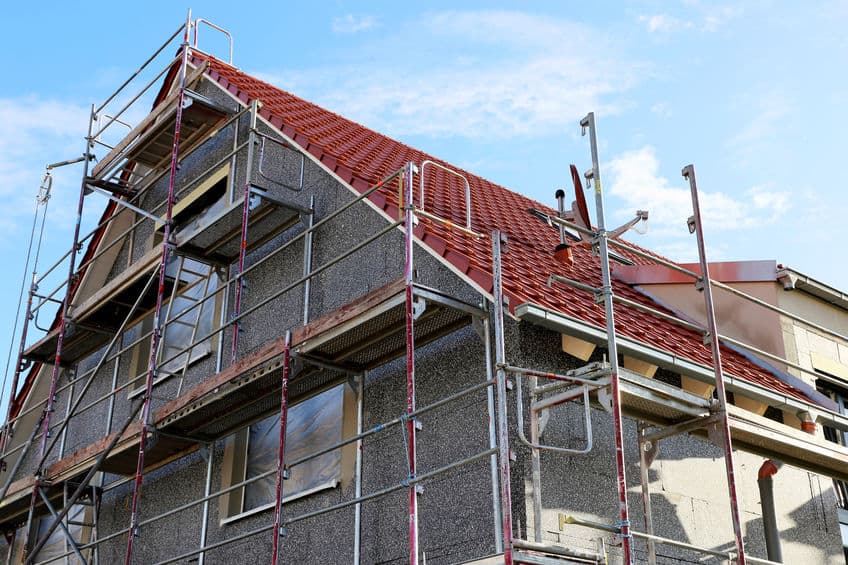 construction site with scaffolding around a house