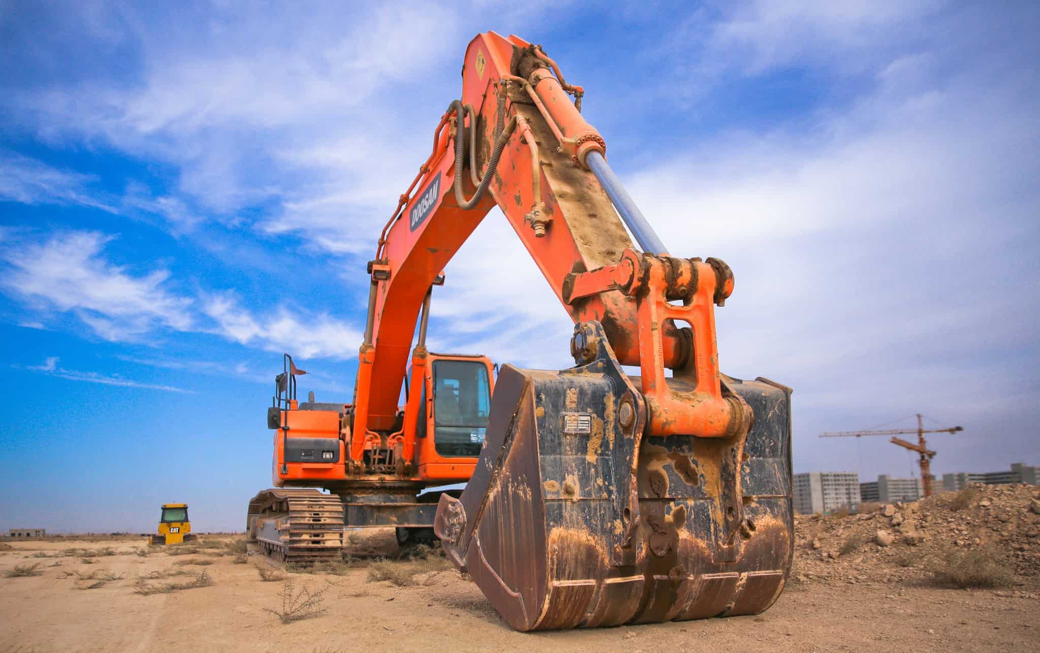 construction equipment digging into the ground at a work site