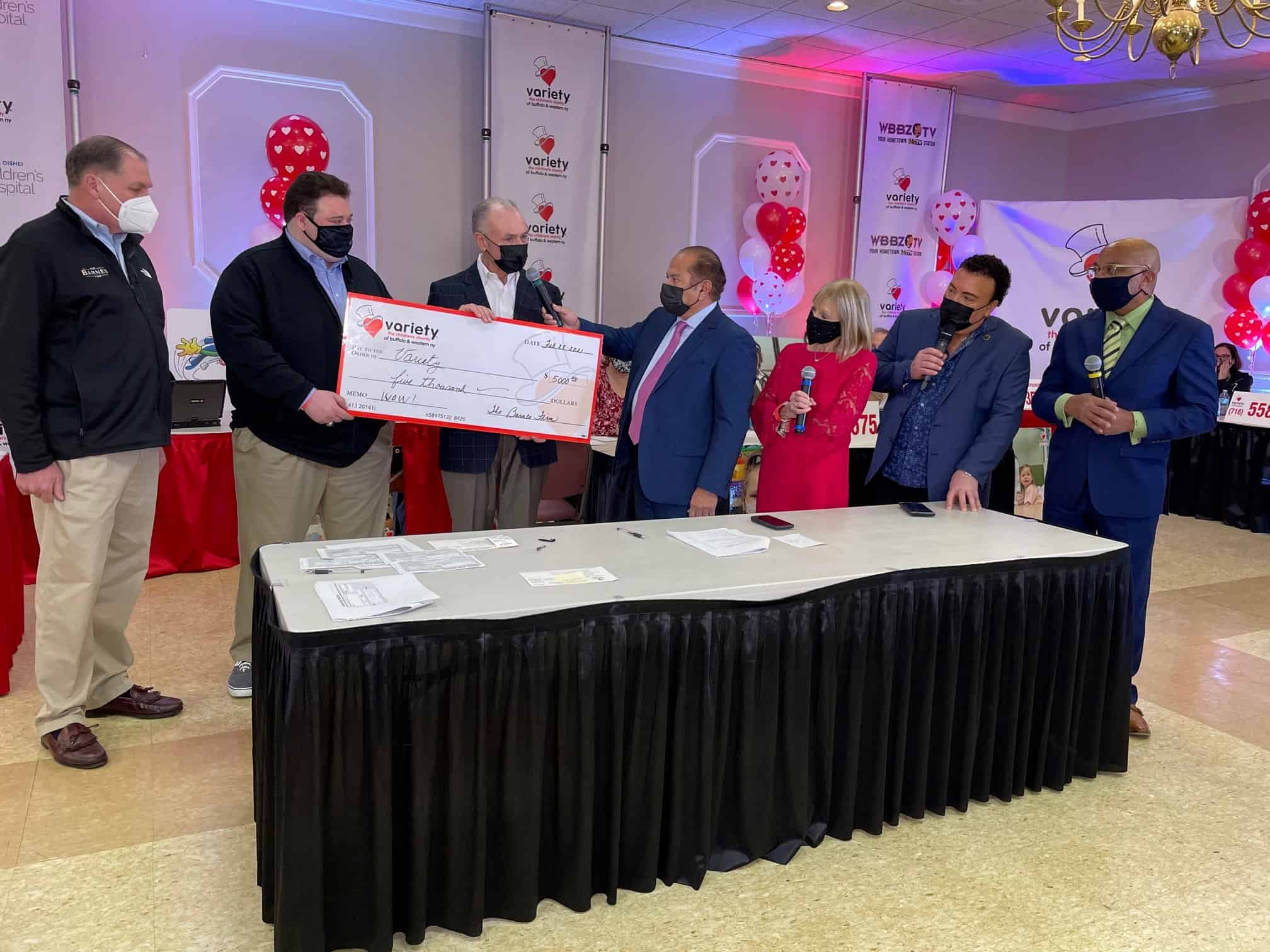 rich barnes at the variety children's chariety donating a $5000 check