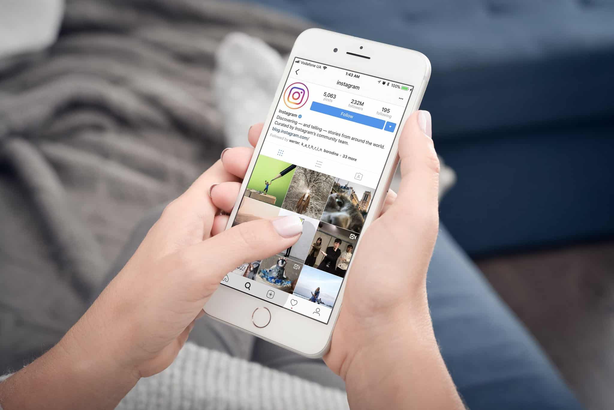 person holding phone with social media app open