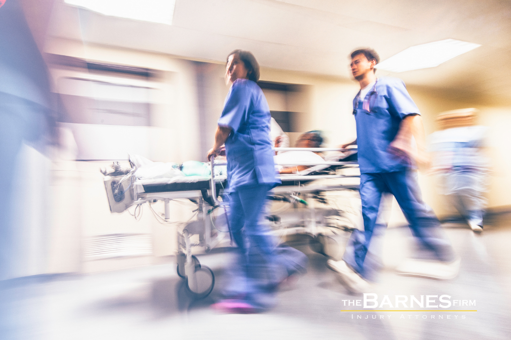 doctors moving a patient on a bed through a hospital