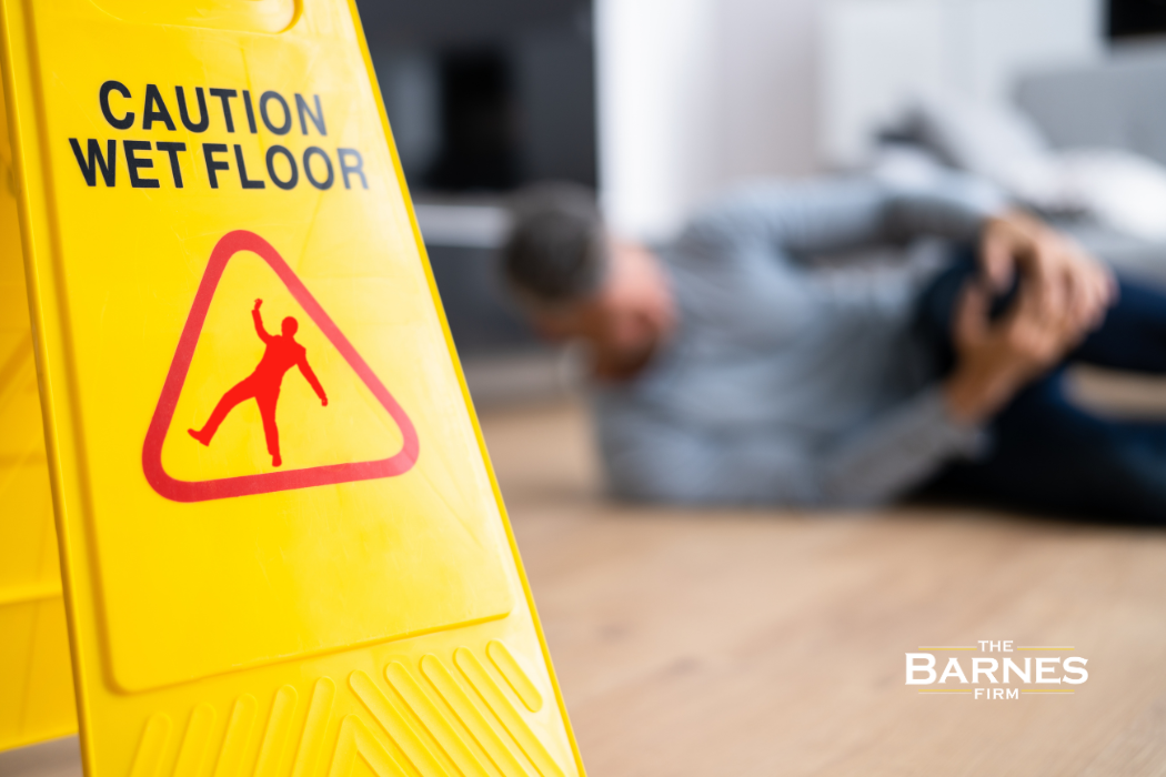 wet floor sign with a man that slipped and fell behind it in Oakland, CA