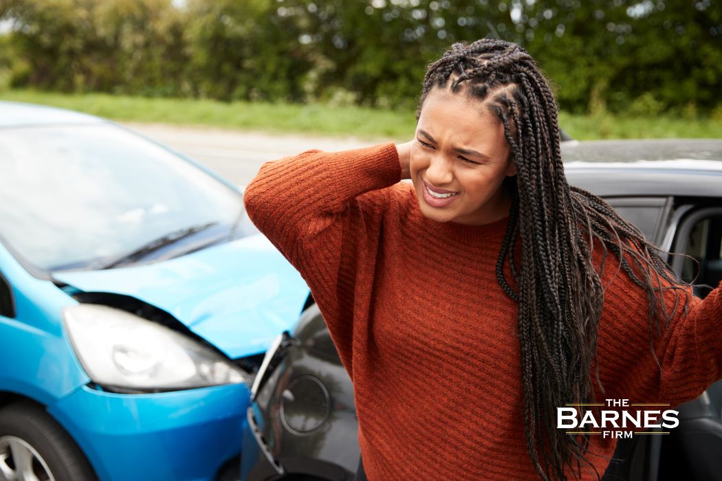 women holding her neck in pain after a car accident